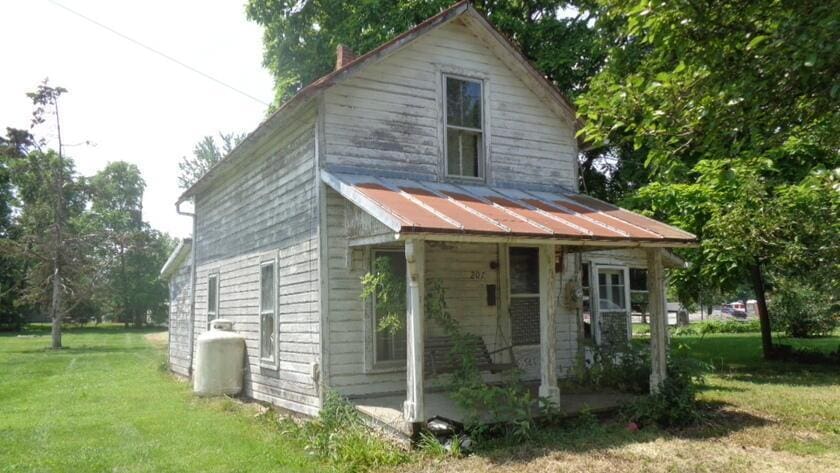 207 Nichols St, Cardington, OH 43315 - view of front of house featuring a front lawn, a metal roof, and a standing seam roof