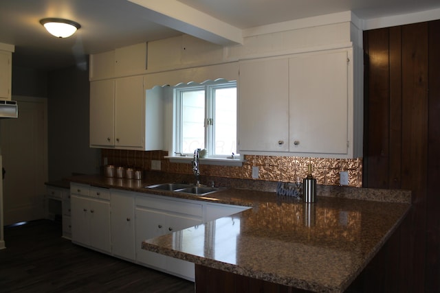 193 E Walnut St, Marion, OH 43302 - kitchen with white cabinetry, a peninsula, dark wood finished floors, decorative backsplash, and dark stone counters