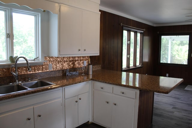193 E Walnut St, Marion, OH 43302 - kitchen featuring a peninsula, white cabinets, wooden walls, and wood finished floors