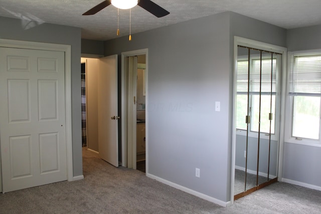 193 E Walnut St, Marion, OH 43302 - unfurnished bedroom featuring carpet flooring, multiple windows, a textured ceiling, and ceiling fan