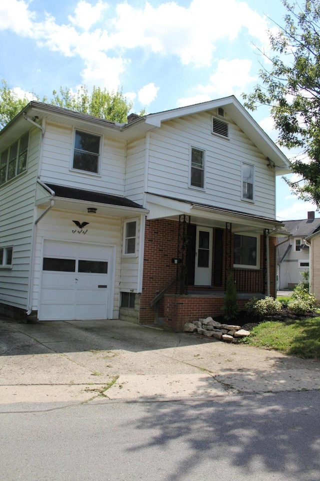 193 E Walnut St, Marion, OH 43302 - view of front of property featuring a porch, a garage, brick siding, and driveway