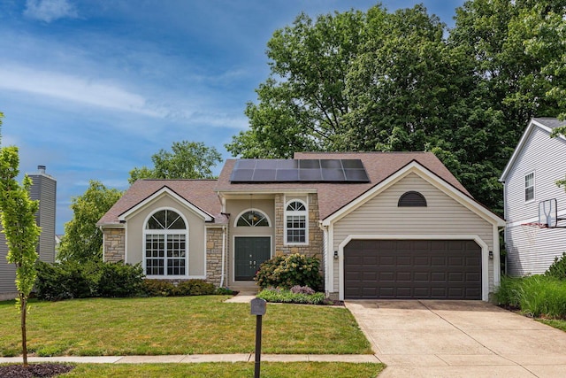 4247 Boulder Creek Dr, Columbus, OH 43230 - view of front of property featuring stone siding, a garage, a front lawn, concrete driveway, and a shingled roof