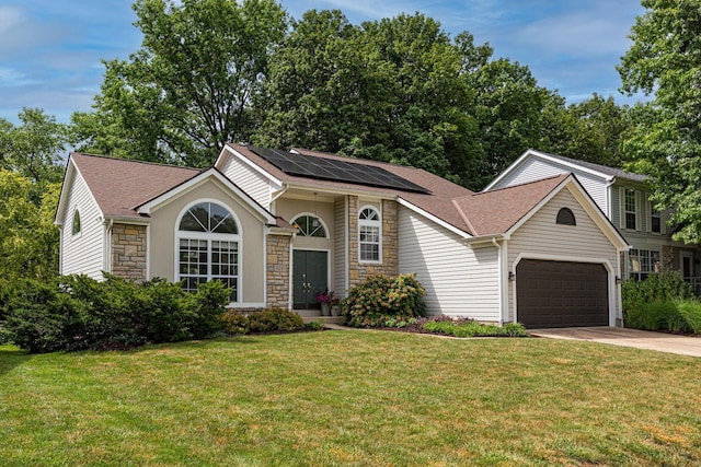 4247 Boulder Creek Dr, Columbus, OH 43230 - view of front of house featuring stone siding, roof mounted solar panels, a front lawn, concrete driveway, and a garage