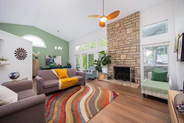 4247 Boulder Creek Dr, Columbus, OH 43230 - living room featuring wood finished floors, high vaulted ceiling, a stone fireplace, ceiling fan, and a chandelier