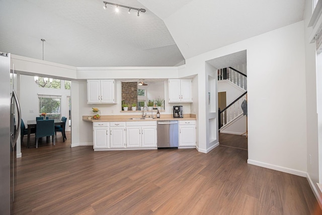 4247 Boulder Creek Dr, Columbus, OH 43230 - kitchen featuring stainless steel appliances, light countertops, white cabinetry, dark wood-type flooring, and lofted ceiling