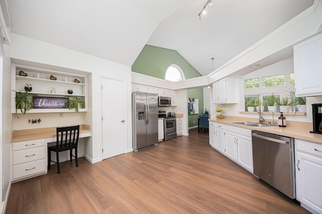 4247 Boulder Creek Dr, Columbus, OH 43230 - kitchen featuring stainless steel appliances, white cabinets, dark wood-type flooring, and vaulted ceiling