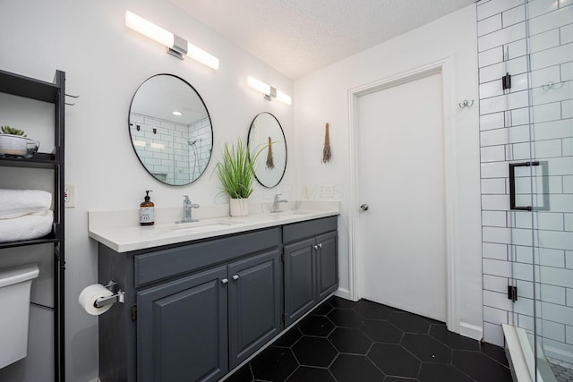 4247 Boulder Creek Dr, Columbus, OH 43230 - full bath featuring double vanity, a textured ceiling, tile patterned floors, and a shower