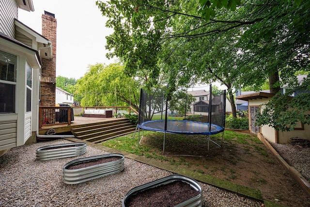 4247 Boulder Creek Dr, Columbus, OH 43230 - view of yard with a trampoline and a wooden deck