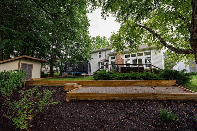 4247 Boulder Creek Dr, Columbus, OH 43230 - rear view of property featuring a trampoline, a wooden deck, and a shed
