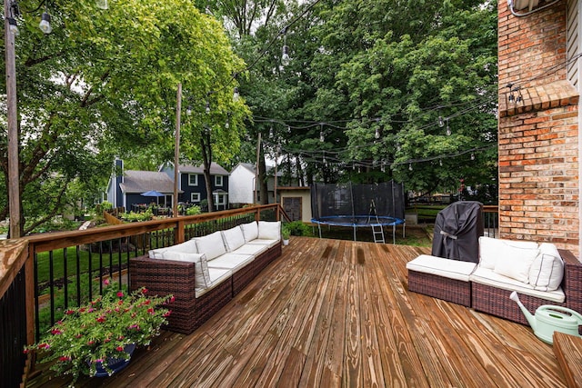 4247 Boulder Creek Dr, Columbus, OH 43230 - wooden terrace featuring outdoor lounge area, a trampoline, a grill, and view of scattered trees