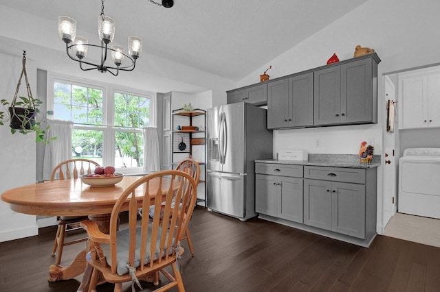 3007 Galen Ct, Hilliard, OH 43026 - dining space with washer / dryer, vaulted ceiling, a chandelier, and dark wood finished floors