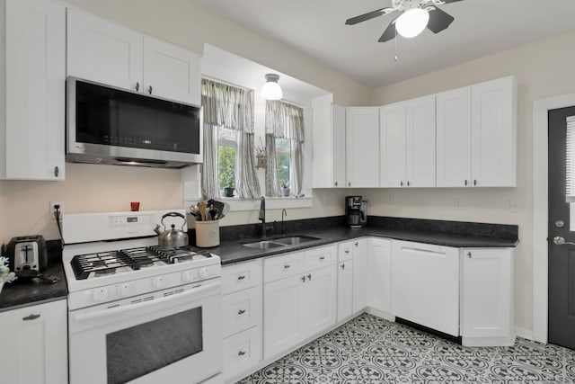 604 Elm St, Groveport, OH 43125 - kitchen with white appliances, a ceiling fan, dark countertops, and white cabinetry