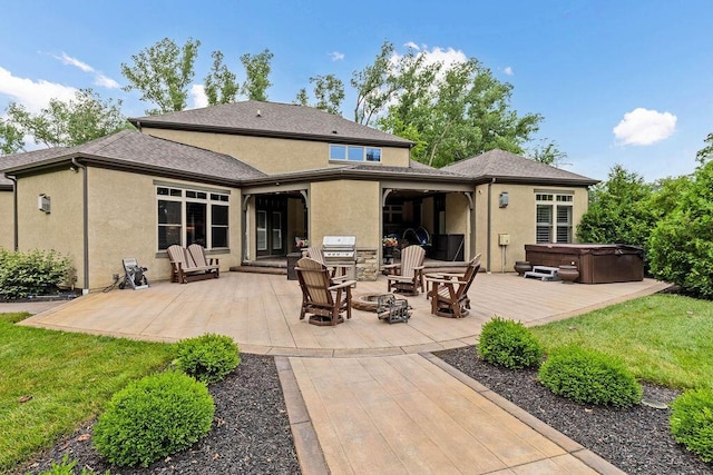 3150 Middle Pike, West Jefferson, OH 43162 - back of house with a hot tub, a patio, stucco siding, and a fire pit