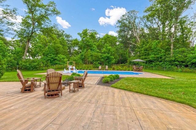 3150 Middle Pike, West Jefferson, OH 43162 - swimming pool with a lawn, an outdoor fire pit, view of wooded area, and a patio