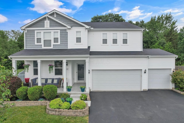 2267 Holiday Valley Dr, Grove City, OH 43123 - view of front of home with covered porch, asphalt driveway, a garage, and a shingled roof