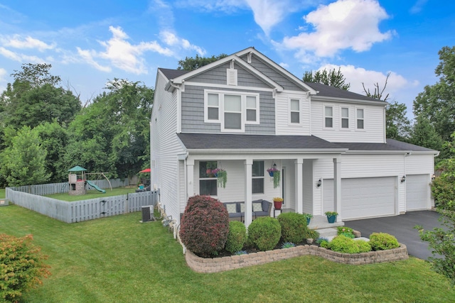 2267 Holiday Valley Dr, Grove City, OH 43123 - view of front of property with covered porch, asphalt driveway, a playground, and an attached garage