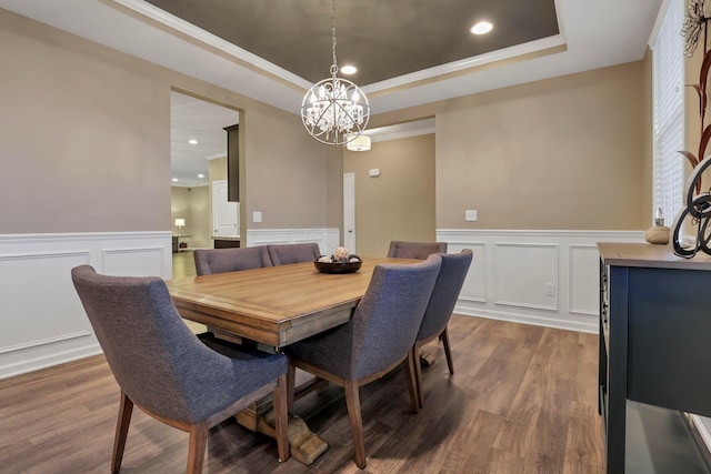 2267 Holiday Valley Dr, Grove City, OH 43123 - dining space with a decorative wall, a chandelier, dark wood finished floors, a raised ceiling, and a wainscoted wall
