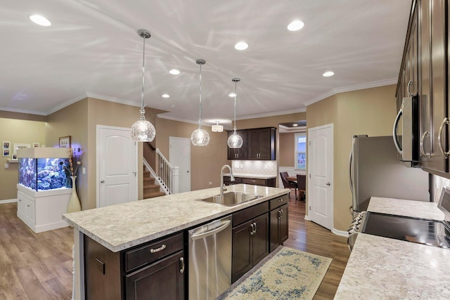 2267 Holiday Valley Dr, Grove City, OH 43123 - kitchen featuring stainless steel appliances, dark brown cabinets, recessed lighting, a center island with sink, and light countertops