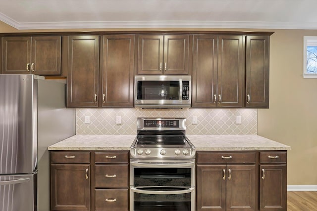 2267 Holiday Valley Dr, Grove City, OH 43123 - kitchen featuring appliances with stainless steel finishes, dark brown cabinets, tasteful backsplash, crown molding, and light wood finished floors