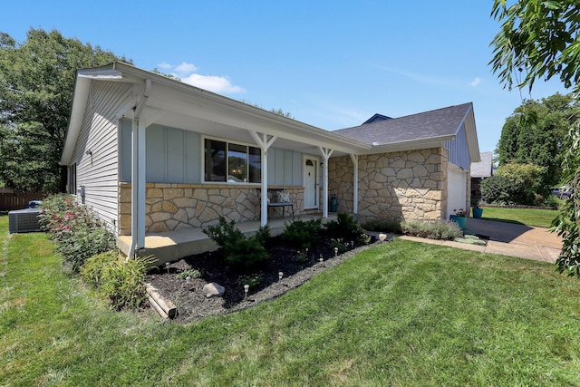 8547 Seabright Dr, Powell, OH 43065 - ranch-style home with stone siding, a porch, an attached garage, board and batten siding, and a front yard