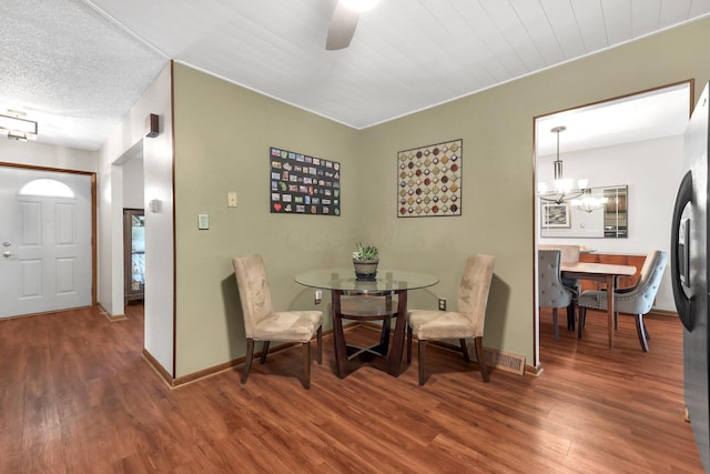 8547 Seabright Dr, Powell, OH 43065 - dining space with wood finished floors, a chandelier, and a ceiling fan