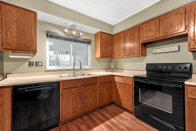 8547 Seabright Dr, Powell, OH 43065 - kitchen with black appliances, wood finished floors, brown cabinets, and light countertops