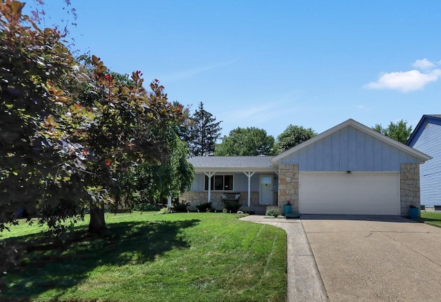 8547 Seabright Dr, Powell, OH 43065 - ranch-style house featuring stone siding, a garage, a front lawn, driveway, and board and batten siding