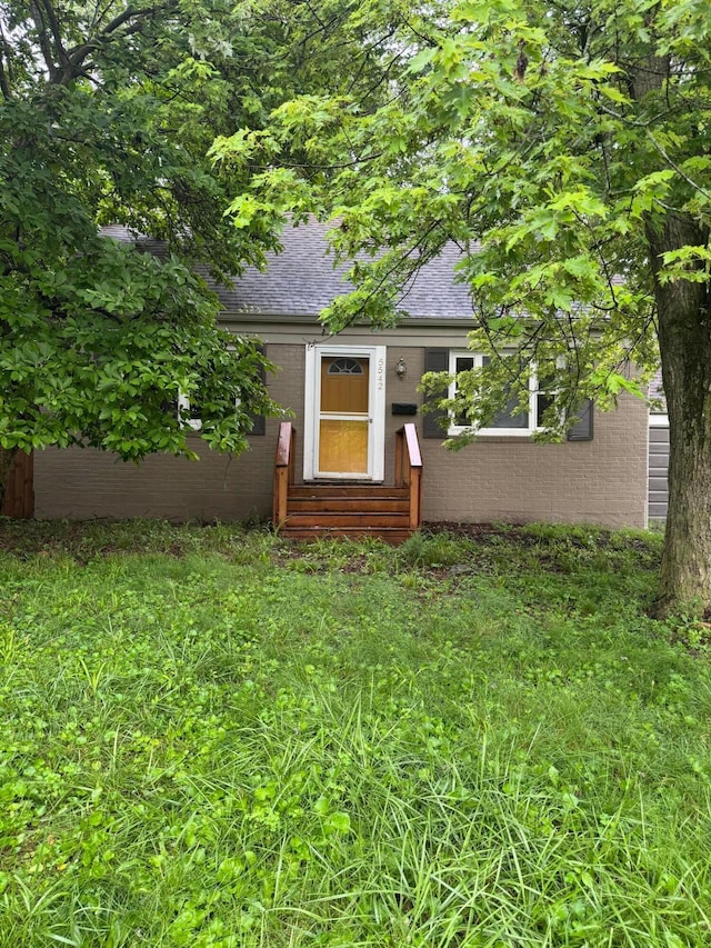 5542 Emerson Ave, Worthington, OH 43085 - property entrance featuring roof with shingles and brick siding