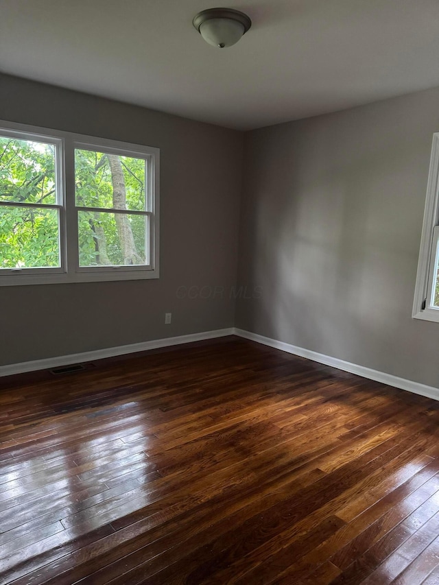 5542 Emerson Ave, Worthington, OH 43085 - spare room featuring dark wood-style floors and healthy amount of natural light