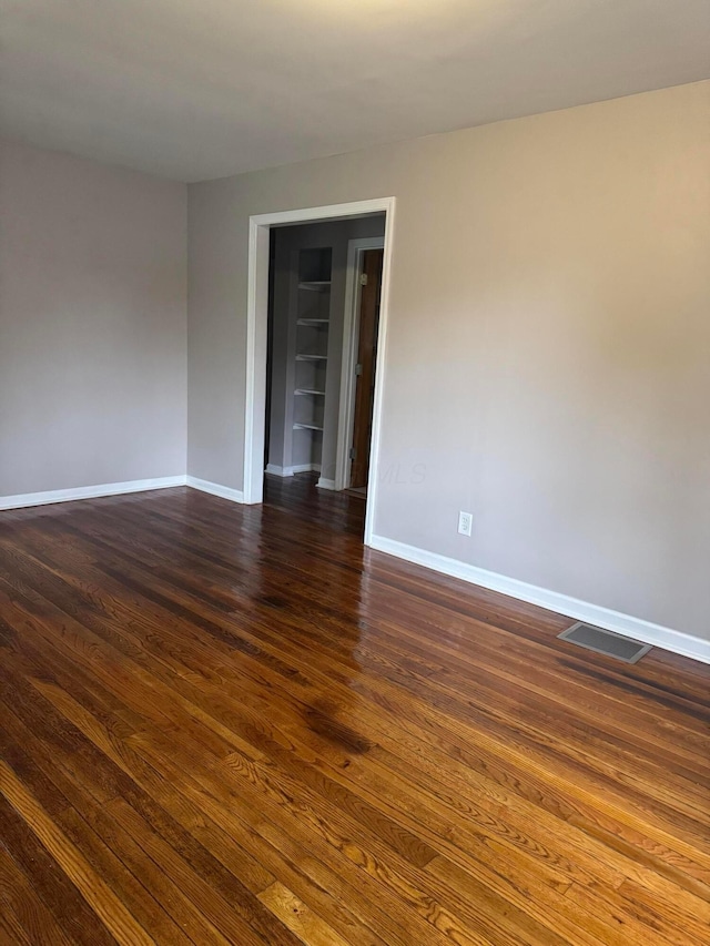 5542 Emerson Ave, Worthington, OH 43085 - spare room featuring built in features and dark wood-style flooring