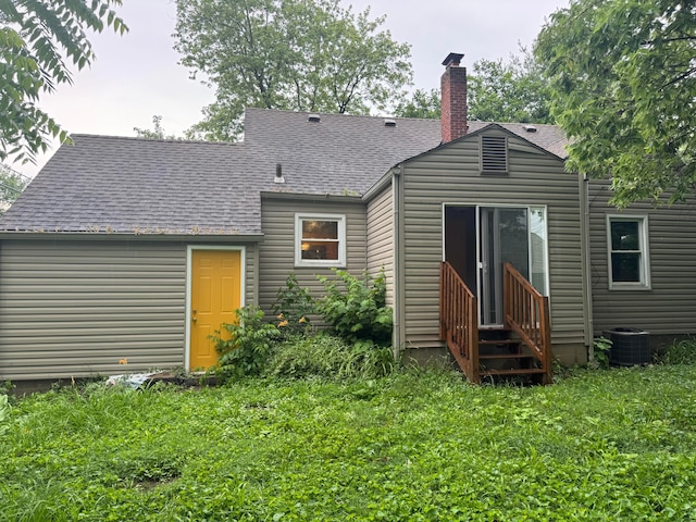 5542 Emerson Ave, Worthington, OH 43085 - rear view of property with a chimney, a shingled roof, entry steps, and a lawn