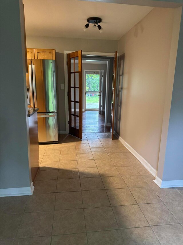 5542 Emerson Ave, Worthington, OH 43085 - corridor featuring light tile patterned flooring and french doors
