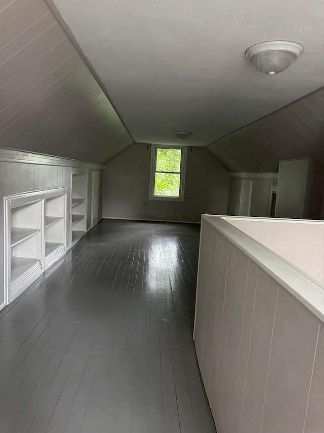 5542 Emerson Ave, Worthington, OH 43085 - additional living space featuring built in shelves, dark wood finished floors, and lofted ceiling