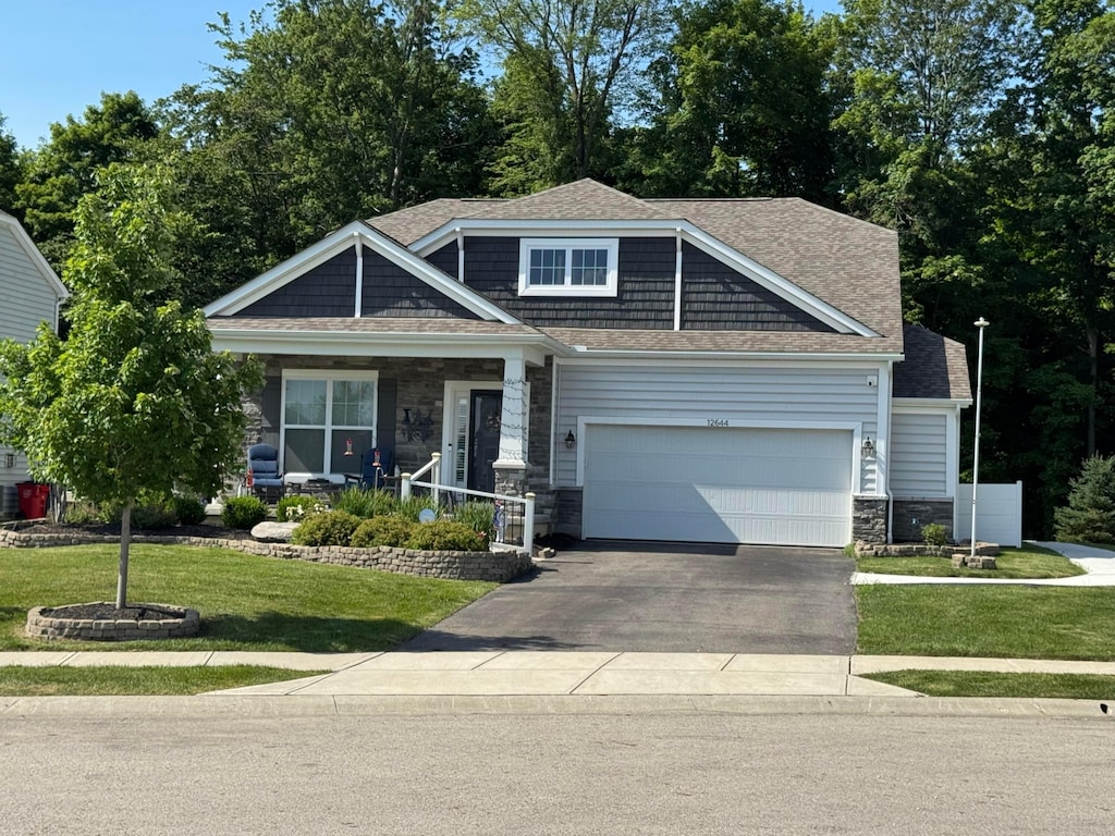 12644 Prairie View Dr NW, Pickerington, OH 43147 - craftsman inspired home with stone siding, a garage, covered porch, driveway, and a front yard