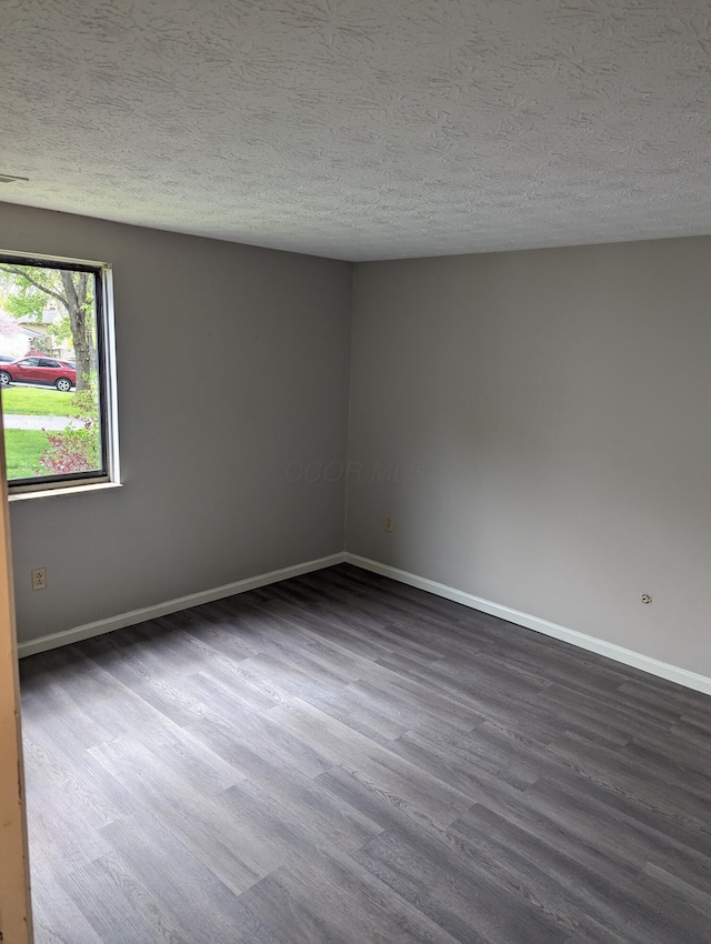 6679 Brock St, Dublin, OH 43017 - spare room with dark wood-style flooring and a textured ceiling
