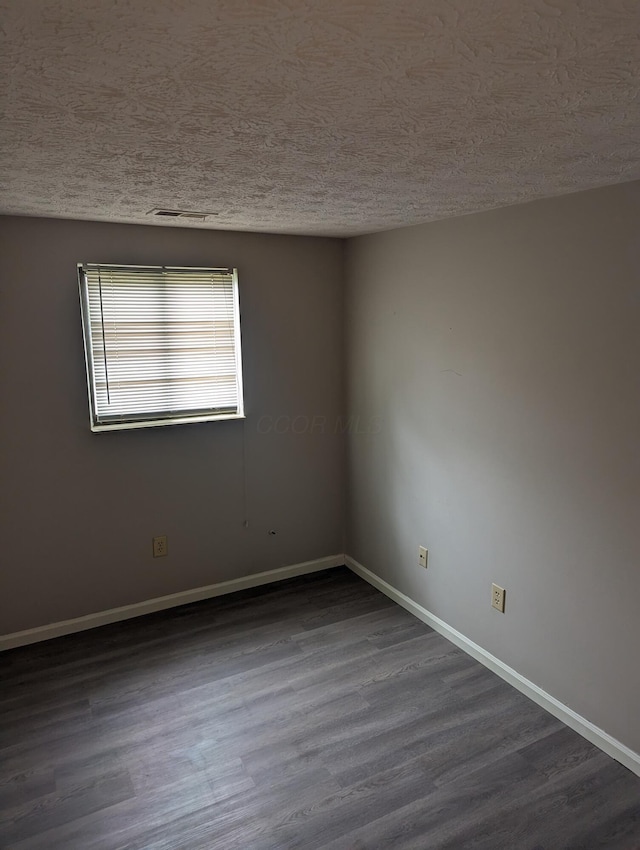 6679 Brock St, Dublin, OH 43017 - empty room with a textured ceiling and dark wood finished floors