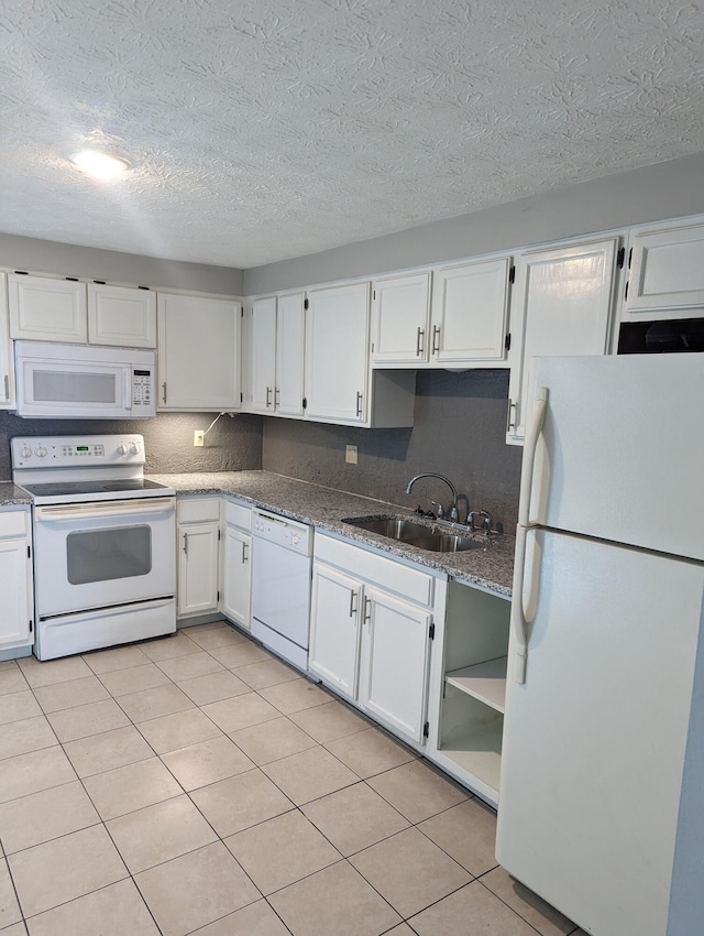 6679 Brock St, Dublin, OH 43017 - kitchen featuring white appliances, white cabinetry, a textured ceiling, light tile patterned floors, and dark stone counters