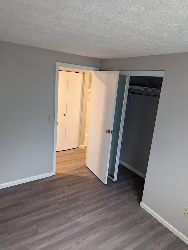6679 Brock St, Dublin, OH 43017 - unfurnished bedroom with wood finished floors, a textured ceiling, and a closet