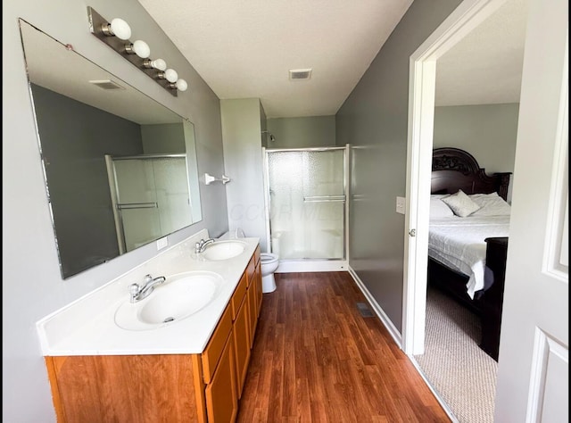 7173 Serenoa Dr, Reynoldsburg, OH 43068 - ensuite bathroom featuring wood finished floors, a stall shower, and double vanity