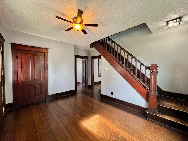 940 W 3rd St, Logan, OH 43138 - unfurnished living room featuring hardwood / wood-style floors, stairway, a textured ceiling, and ceiling fan
