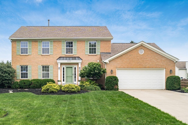 2063 Hayer Ct, Lewis Center, OH 43035 - colonial-style house with brick siding, driveway, a front lawn, and an attached garage