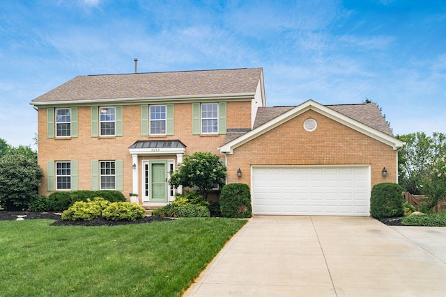 2063 Hayer Ct, Lewis Center, OH 43035 - colonial-style house with brick siding, driveway, a front yard, and a garage