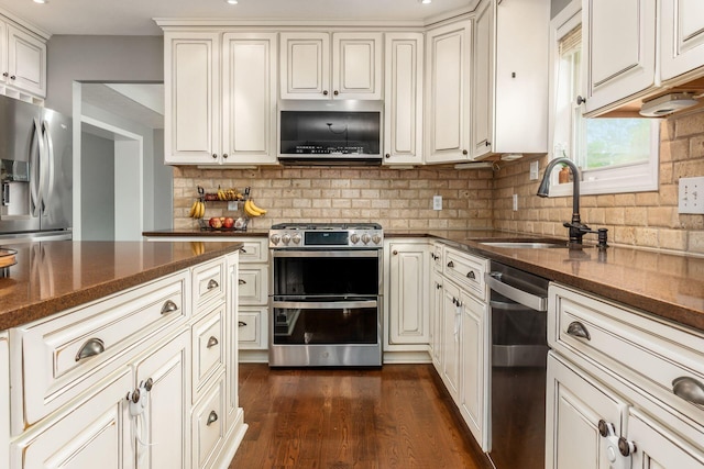 2063 Hayer Ct, Lewis Center, OH 43035 - kitchen featuring appliances with stainless steel finishes, tasteful backsplash, dark wood finished floors, dark stone countertops, and recessed lighting