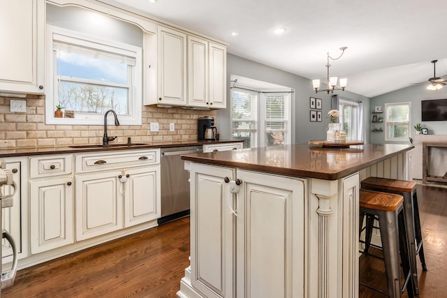 2063 Hayer Ct, Lewis Center, OH 43035 - kitchen with stainless steel dishwasher, open floor plan, backsplash, a kitchen island, and vaulted ceiling