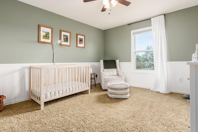 2063 Hayer Ct, Lewis Center, OH 43035 - carpeted bedroom with wainscoting, a nursery area, and ceiling fan