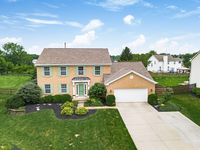 2063 Hayer Ct, Lewis Center, OH 43035 - colonial-style house with an attached garage, driveway, and a shingled roof