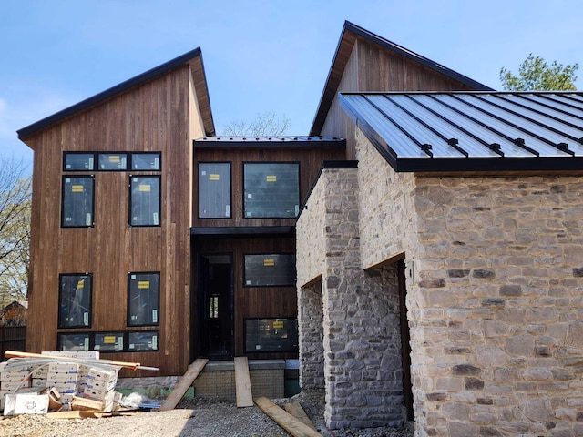 3134 Asbury Dr, Upper Arlington, OH 43221 - property entrance with a standing seam roof, stone siding, and a metal roof