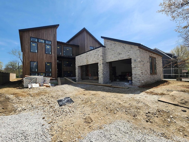 3134 Asbury Dr, Upper Arlington, OH 43221 - rear view of house with an attached garage and stone siding