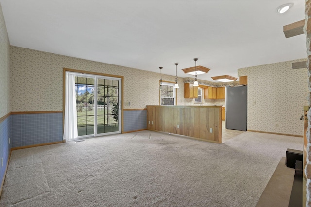 19 Kirby Rd, Heath, OH 43056 - unfurnished living room featuring wallpapered walls, a wainscoted wall, and light colored carpet