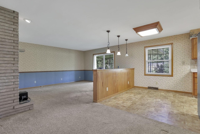 19 Kirby Rd, Heath, OH 43056 - kitchen featuring wallpapered walls, healthy amount of natural light, carpet, a wainscoted wall, and hanging light fixtures